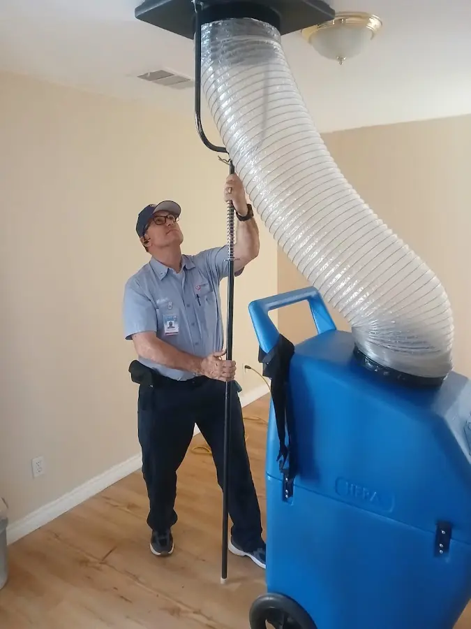 Furnace Tune-Up technician using HEPA equipment in Clovis